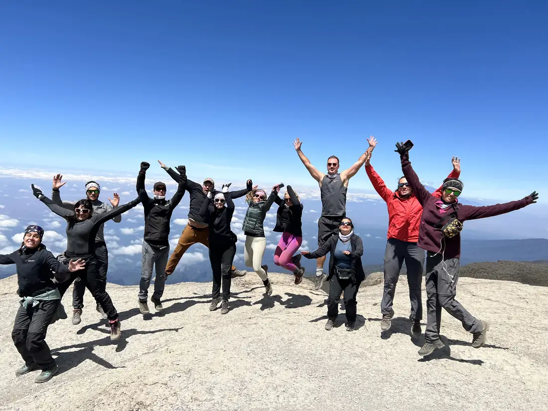 A small group celebrating above the clouds